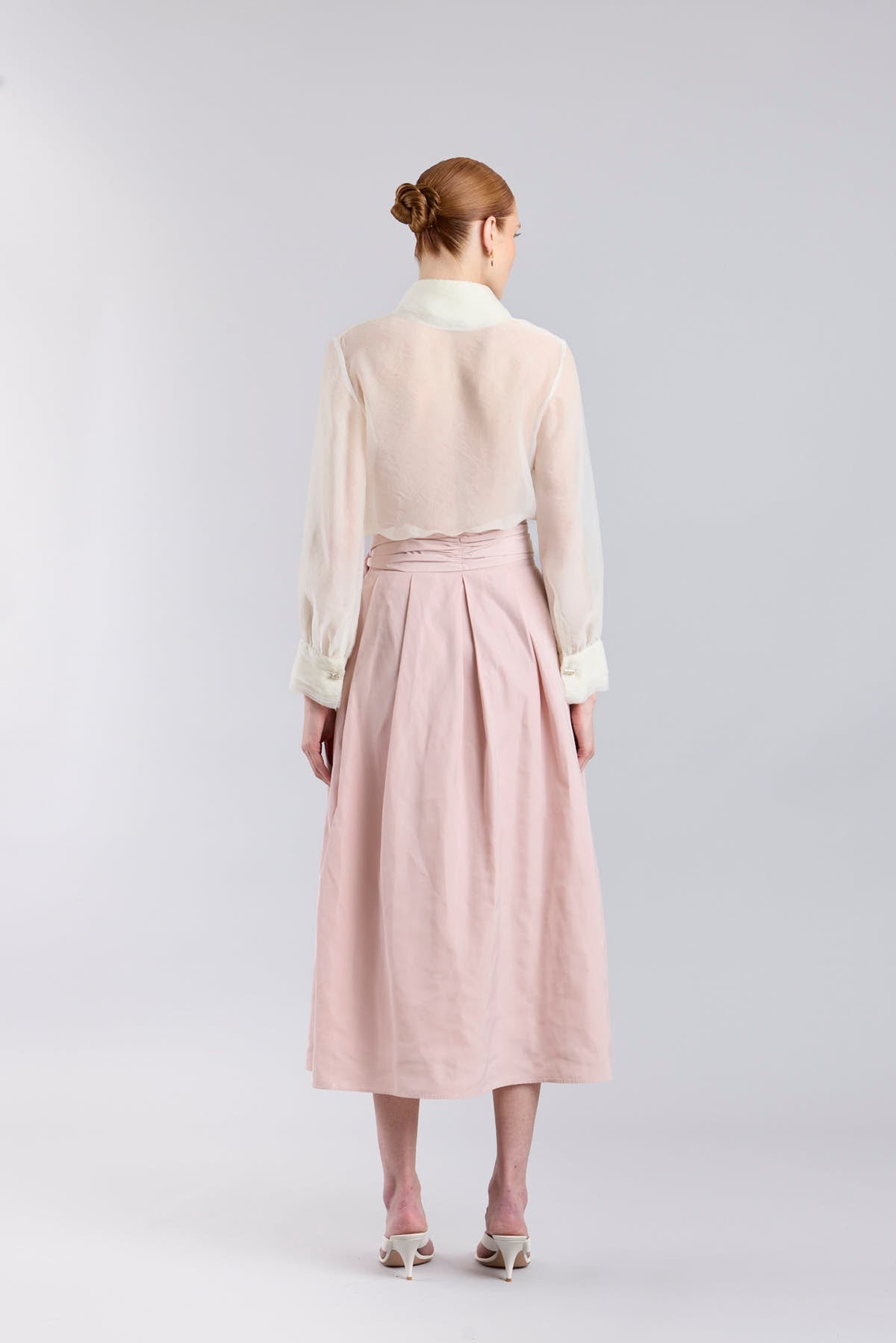 Falda midi rosa empolvado con volumen y lazo en la cintura de The Extreme Collection.